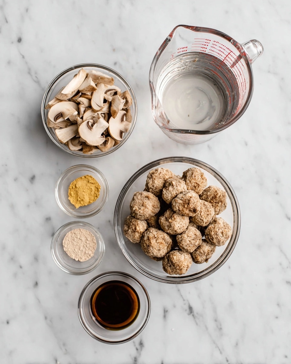 On a white marbled surface, there are six glass bowls and a glass measuring cup arranged neatly. The top right bowl is a clear glass measuring cup filled with water, showing measurement marks in red. Below it is a small glass bowl filled with beige mushroom pieces, some sliced and some whole. To the left of the mushrooms is a glass bowl holding a light brown powder, smooth in texture. Below the powder is a tiny glass bowl containing two small piles of yellow and white powders. Near the bottom right side, another small glass bowl holds a dark brown liquid with a shiny surface. Finally, the largest bowl, slightly below and to the right of the powder bowl, contains many round, light brown meatballs with a crumbly texture. photo taken with an iphone --ar 4:5 --v 7