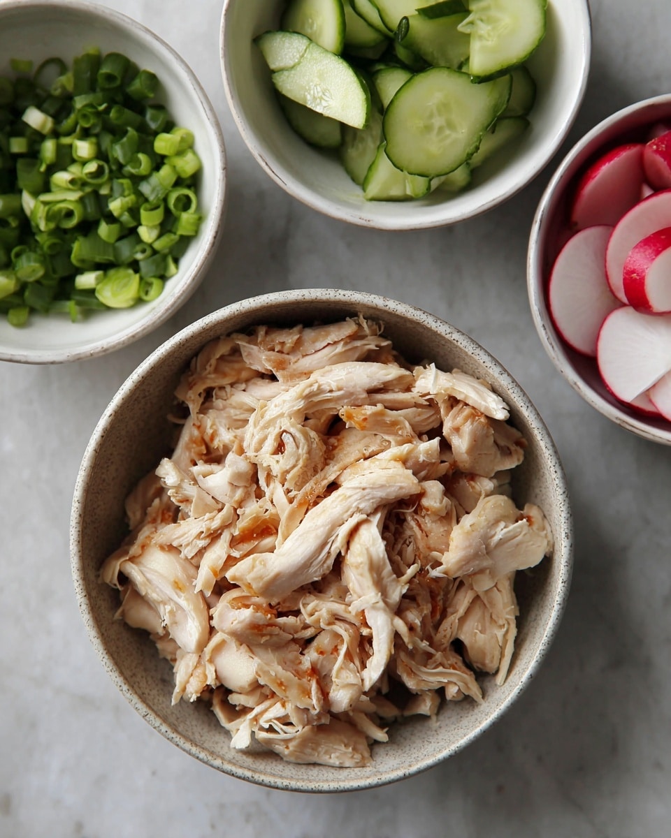 In the center is a bowl filled with shredded cooked chicken pieces showing light brown and white colors with a soft texture, surrounded by three white bowls: the top left bowl contains chopped green onions with bright green and white bits, the top right bowl has sliced cucumbers with a bright green peel and pale green flesh, and the bottom right bowl holds thinly sliced radishes with white centers and red edges. All bowls sit on a white marbled surface. photo taken with an iphone --ar 4:5 --v 7