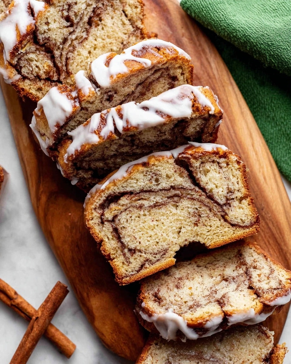 The image shows several thick slices of cinnamon swirl loaf bread arranged on a wooden cutting board with a white marbled surface underneath. Each slice has a soft, light brown texture with a dark cinnamon swirl running across its middle, creating a marbled pattern. The loaf has a slightly crispy, golden-brown crust with a drizzle of white icing on top, which is uneven and drips down the sides of some slices. A torn smaller piece of the bread with icing on top lies on one slice, adding extra texture contrast. A green cloth is visible in the top right corner, partially placed on the white marbled surface, and two cinnamon sticks are at the bottom left of the image. Photo taken with an iphone --ar 4:5 --v 7