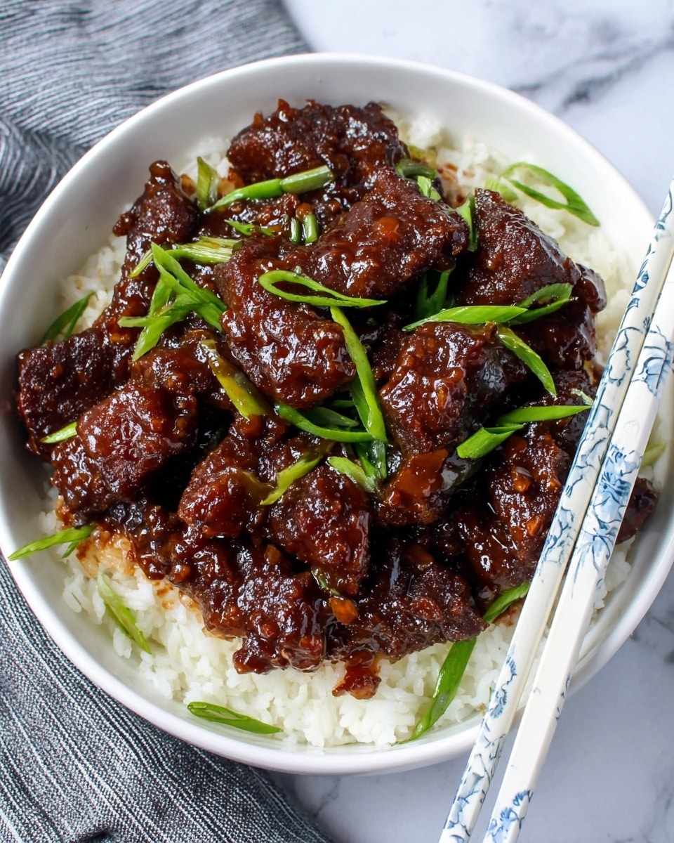 A white bowl filled with a layer of white cooked rice at the bottom, topped with glossy dark brown pieces of meat coated with a thick sauce. Green chopped scallions are scattered on top of the meat, adding a fresh touch. A pair of white chopsticks with blue patterns rest on the right side over the food. The bowl sits on a surface with a white marbled texture, and a grey striped cloth is visible on the left side. photo taken with an iphone --ar 4:5 --v 7