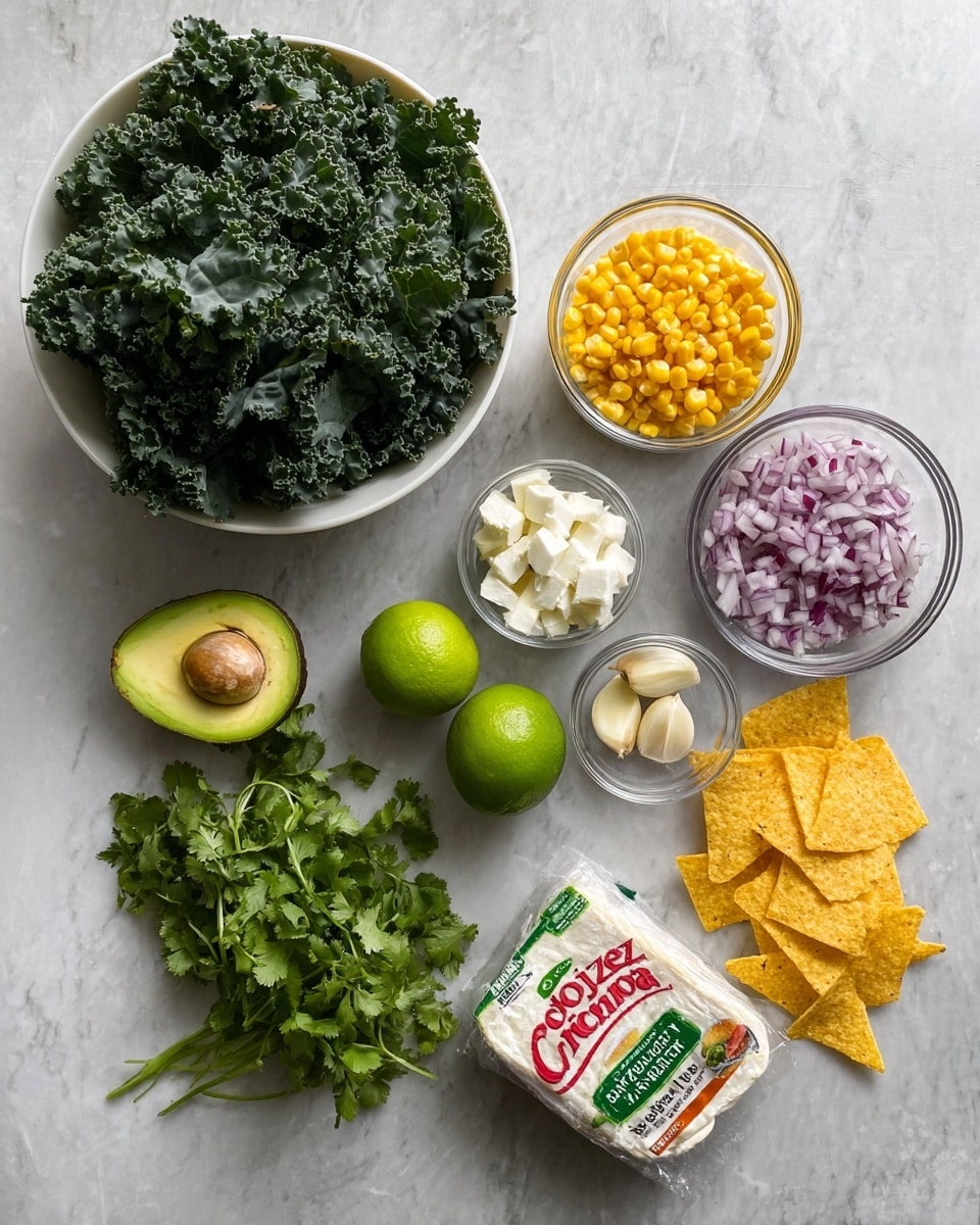 The image shows a flat lay of fresh ingredients on a white marbled surface. There is a large white bowl filled with dark green kale leaves at the top left. To its right, a small clear glass bowl holds bright yellow corn kernels. Below, a small clear bowl contains finely chopped red onion, and next to it, another clear bowl has white cheese curds. Two peeled garlic cloves sit in the middle of the frame. Beside these, there are two bright green whole limes. Near the bottom left, a halved avocado with a dark green outer skin and light green flesh is placed next to a bunch of fresh green cilantro. At the bottom right, there are a few yellow corn chips scattered beside a small pile of red chili powder. A wrapped package of white Cotija cheese with red and green labeling lies near the kale bowl. photo taken with an iphone --ar 4:5 --v 7