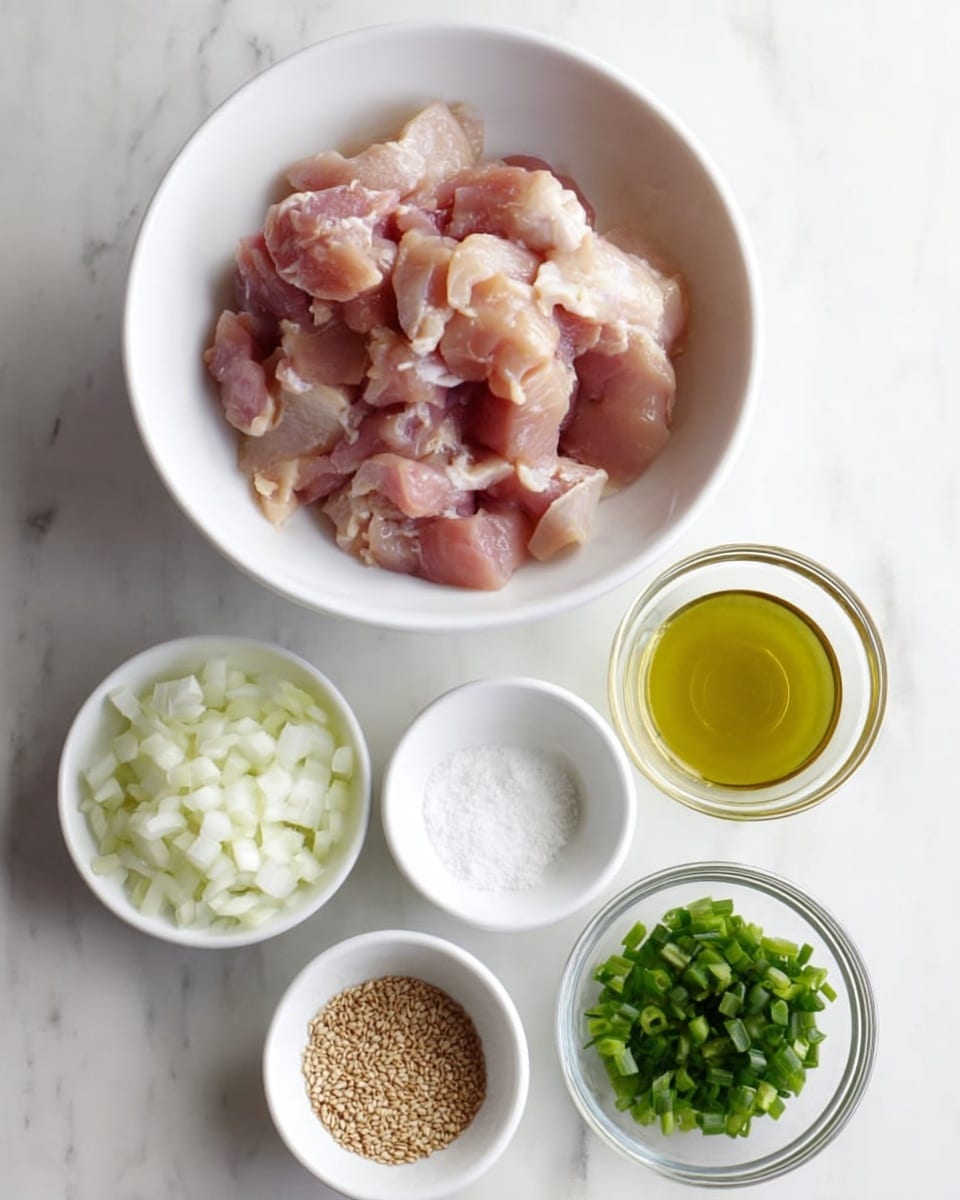 A white bowl in the center filled with raw pieces of chicken that are pink with a bit of white fat, surrounded by five small white bowls arranged in a loose circle below it. The bowls contain chopped white onion pieces, a white powdery substance, clear light yellow oil, chopped green onions, and light brown sesame seeds. All items are placed on a white marbled surface. Photo taken with an iphone --ar 4:5 --v 7