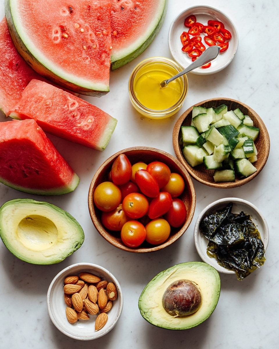 The image shows a top view of fresh ingredients arranged on a white marbled surface. There are three large watermelon pieces with red juicy flesh and a light green rind positioned at the top right, bottom left, and center. Two avocado halves with smooth green skin and creamy light green flesh are placed near the bottom right, one with a large brown seed in the center. A wooden bowl filled with red and yellow cherry tomatoes sits in the middle, showing smooth, round, shiny surfaces. Next to it on the right is another wooden bowl with chopped cucumber pieces, displaying a dark green peel and light green inside. On the bottom left, a small white dish holds peeled almonds, while a small white bowl above it contains a few small red chili peppers in vinegar. Near the top center is a small jar with a spoon inside, filled with a yellow creamy sauce. Finally, a small white dish at the top right corner holds dark green dried seaweed pieces. Photo taken with an iphone --ar 4:5 --v 7