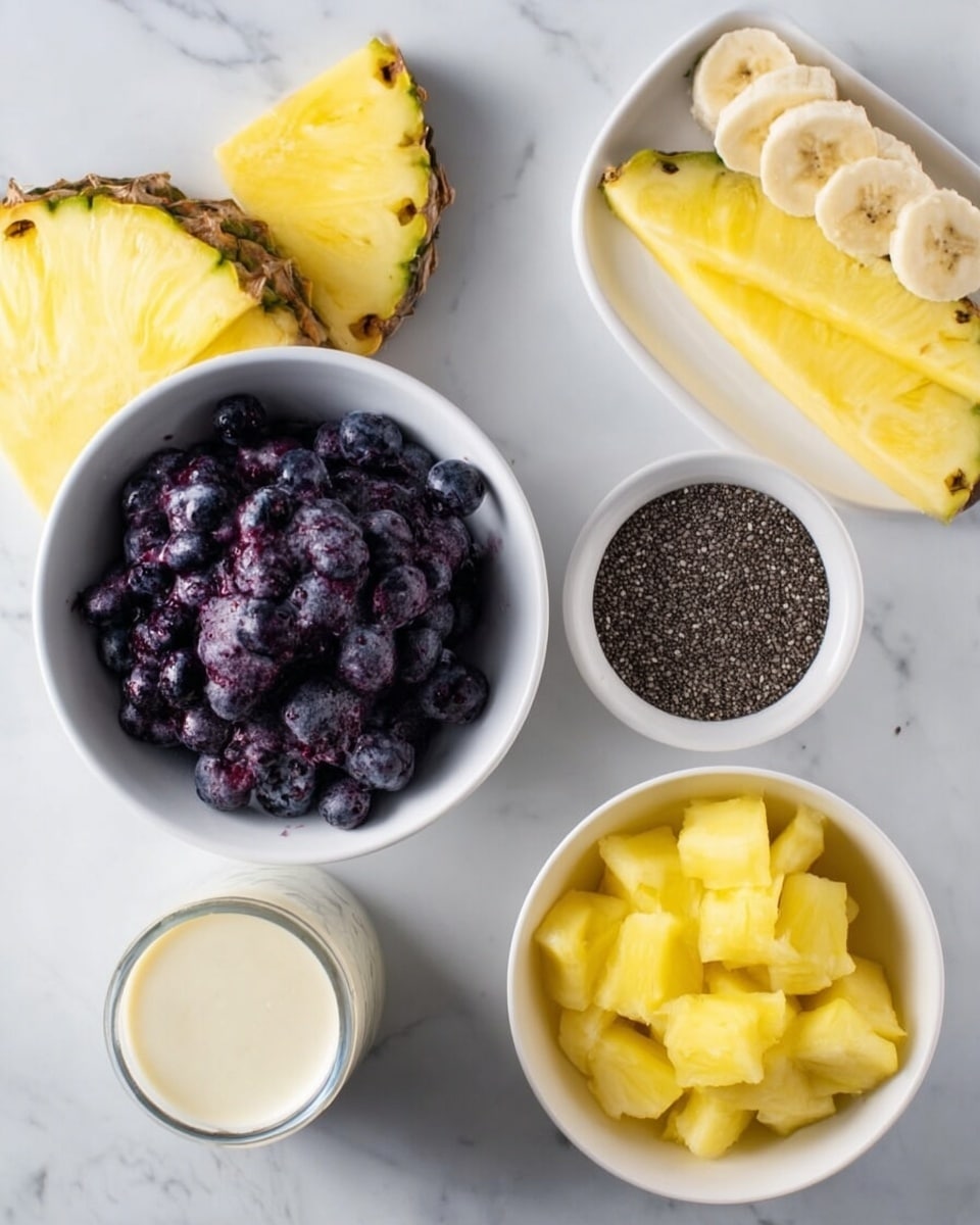 The image shows four white bowls on a white marbled background. The top-left bowl is filled with dark purple frozen blueberries with a few slices of banana on top. On the top-right, a small white bowl holds black chia seeds. The bottom-right bowl contains small yellow pineapple chunks. At the lower-left, there is a transparent container with a creamy white liquid. Near the edge of the frame on the left side, there is a slice of pineapple. The scene is bright and the colors of the fruit stand out clearly. photo taken with an iphone --ar 4:5 --v 7