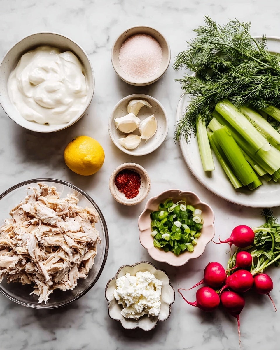 The image shows an overhead view of several bowls and a white plate arranged on a white marbled surface. At the bottom left is a large transparent bowl filled with shredded cooked meat that is light brown and white. Moving clockwise, there is a large white bowl at the top left filled with thick white cream. Next to it are three small bowls: one with pink coarse salt, one with three white garlic cloves, and one with a bright yellow lemon half. Below these is a small white bowl with red powder inside. To the right is a small pink bowl filled with chopped green onions. Below it is a small white, flower-shaped bowl with crumbly white cheese. On the far right, a large white plate holds green cucumber halves, a bunch of fresh green dill, and bright red radishes with green leaves still attached. photo taken with an iphone --ar 4:5 --v 7