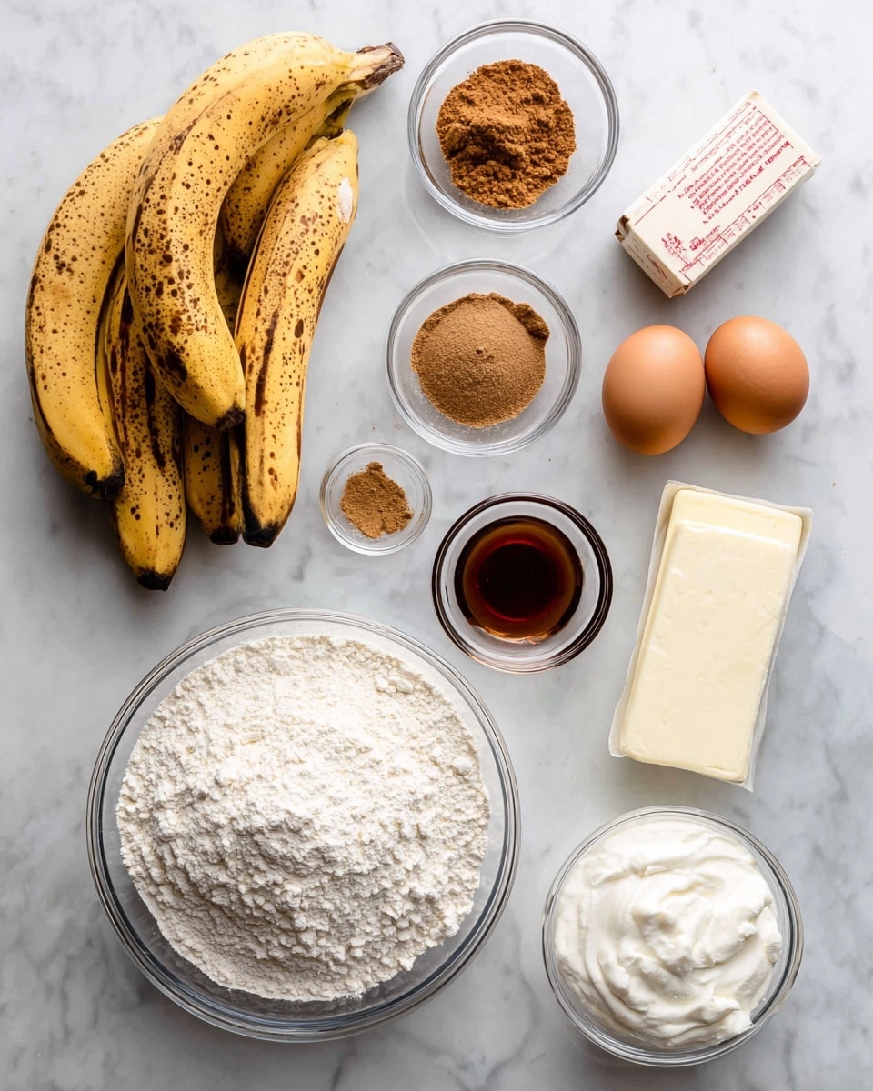 The image shows a white marbled surface with baking ingredients neatly arranged. There is a bunch of ripe bananas with dark spots on the left side. Near the middle, a large clear glass bowl filled with white flour sits prominently. Around it are small clear glass bowls holding brown sugar, ground cinnamon, baking powder, and vanilla extract. There are two brown eggs positioned near a white stick of butter with red writing. A small mound of white sour cream is in a clear glass container to the right. The items are all spaced evenly to show each ingredient clearly. Photo taken with an iphone --ar 4:5 --v 7