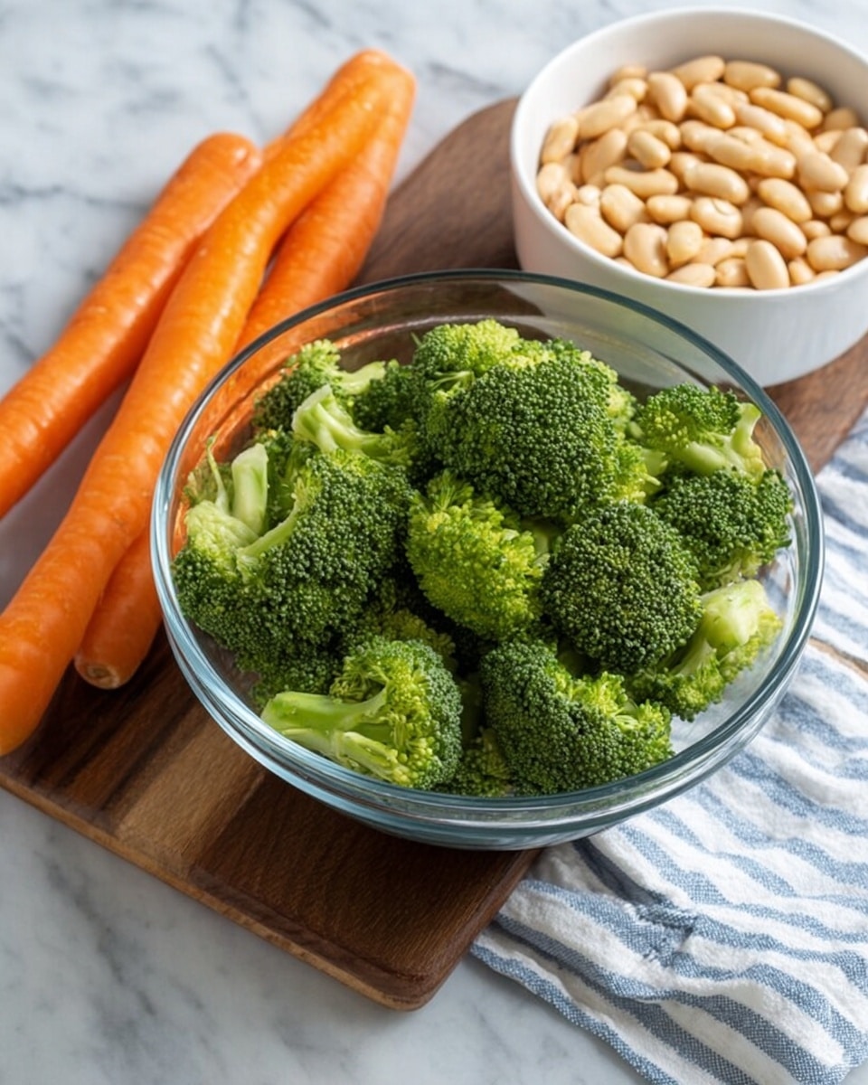 A clear glass bowl filled with fresh bright green broccoli pieces sits on a dark wooden board, next to three whole orange carrots lying directly on the white marbled surface. Nearby, a white bowl contains light beige beans and rests on a white and blue striped cloth also on the white marbled surface. The scene is bright and simple, showing fresh vegetables ready for cooking. photo taken with an iphone --ar 4:5 --v 7