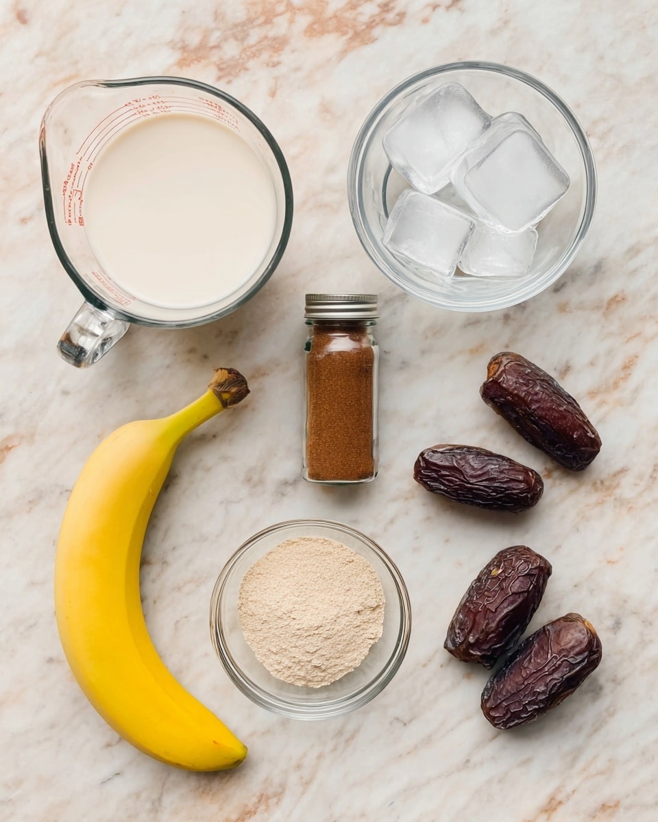 A white marbled surface holds six items neatly arranged: a glass measuring cup filled with white milk in the top left, a clear glass bowl with ice cubes in the top right, a brown spice bottle with a metal lid centered at the top, a yellow ripe banana placed horizontally near the bottom left, a small clear glass bowl containing pale beige powder at the center, and six dark brown dates scattered in the bottom right area. photo taken with an iphone --ar 4:5 --v 7