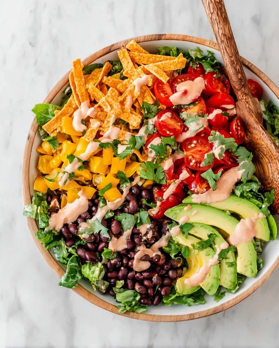 A white bowl with a wooden rim sits on a white marbled surface. Inside, the bottom layer is dark green lettuce leaves. On top, there are four main sections: bright yellow diced bell peppers mixed with green jalapenos and some small red tomato halves on the bottom left. Next, black beans with some scattered lettuce near the bottom right center. At the top right, three light green avocado slices slightly overlapping each other with fresh green cilantro leaves around the edges. Finally, in the top left section, there are orange crunchy tortilla strips with more red tomato halves. The whole bowl is drizzled with a light pink creamy sauce. A wooden spoon is placed on the right side in the bowl. Photo taken with an iphone --ar 4:5 --v 7