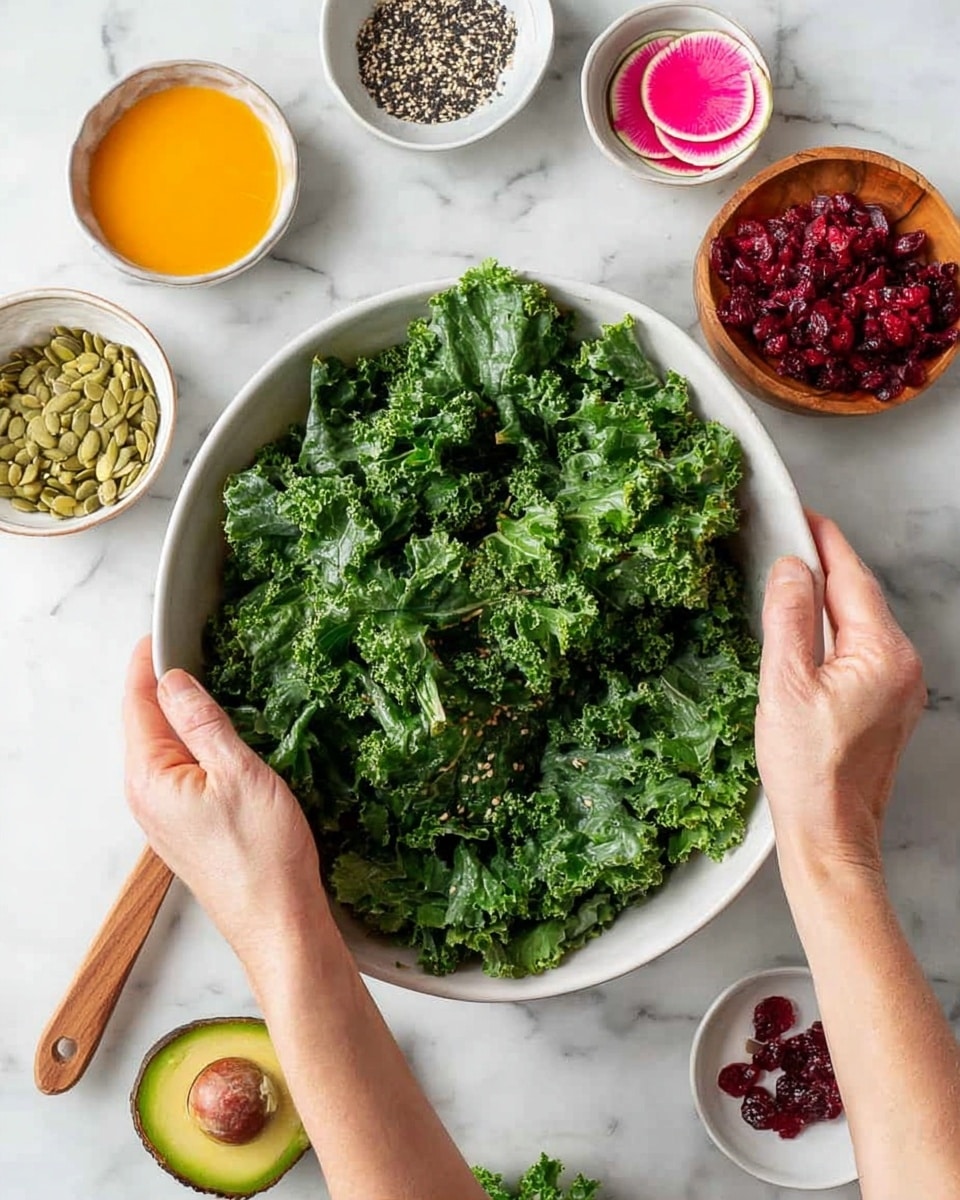 A large white bowl filled with many fresh green kale leaves with curly edges shapes the base layer. Two woman's hands are holding and mixing the kale in the bowl. Around the bowl on a white marbled surface, there are small white and wooden bowls holding arranged ingredients: bright orange dressing with a wooden spoon, pale green pumpkin seeds, deep red dried cranberries, red shredded beets, black and white sesame seeds, and a half avocado with a brown seed. Also, a small round slice of watermelon radish with pink and green colors is visible near the top. photo taken with an iphone --ar 4:5 --v 7