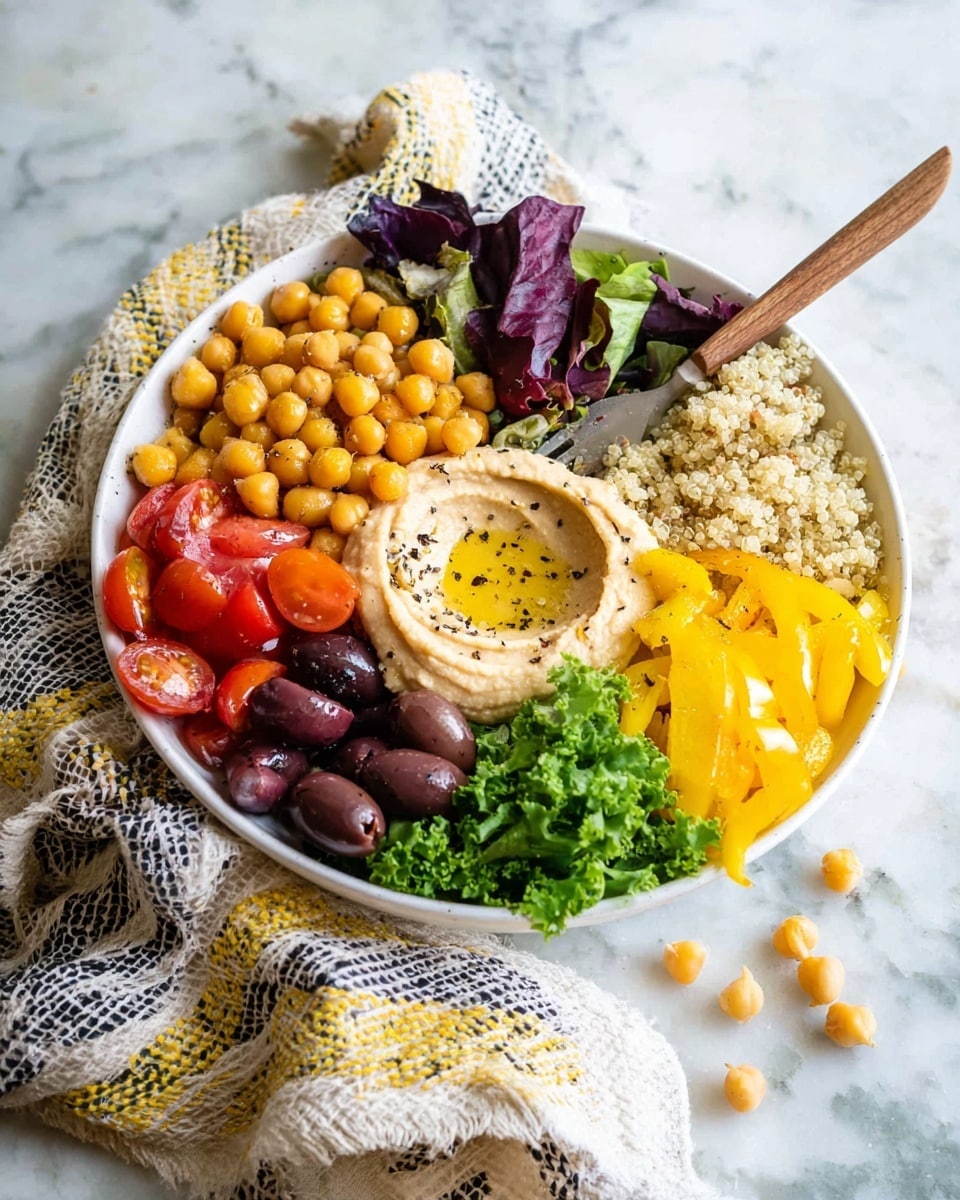 A white bowl filled with several vibrant layers of food arranged side by side: at the front left, dark purple lettuce leaves with ruffled edges; next to it, bright red halved cherry tomatoes; in the center, golden roasted chickpeas seasoned with herbs; to the right, light green cucumber cubes speckled with black pepper; above the chickpeas and cucumbers, a light beige smooth hummus swirl topped with a drizzle of olive oil and some black pepper; behind the hummus, a mound of light brown cooked grains; to the upper right, a small pile of black olives and pieces of yellow roasted squash; all placed on a white marbled surface. photo taken with an iphone --ar 4:5 --v 7